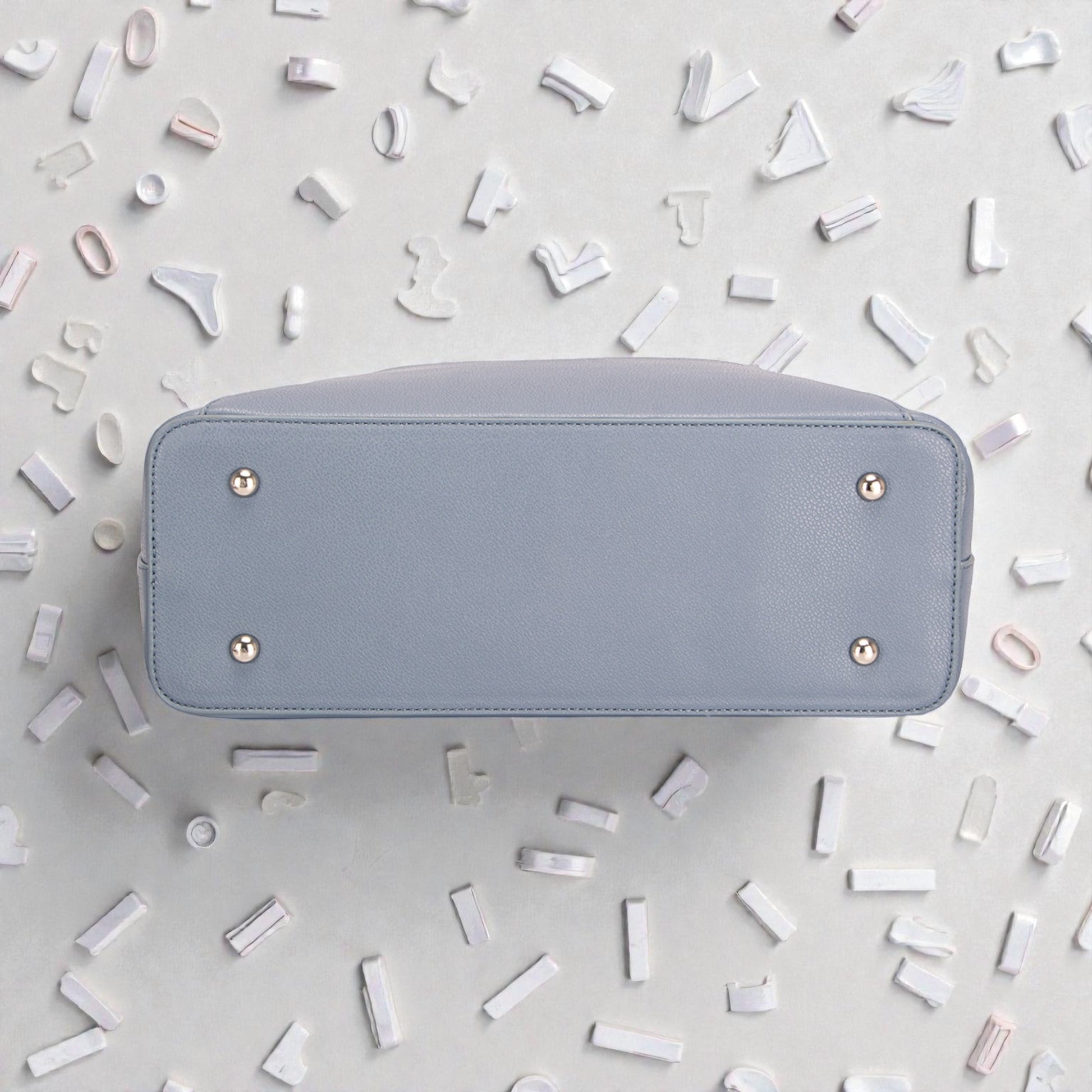 Light blue wallet on a light gray background with decorative elements