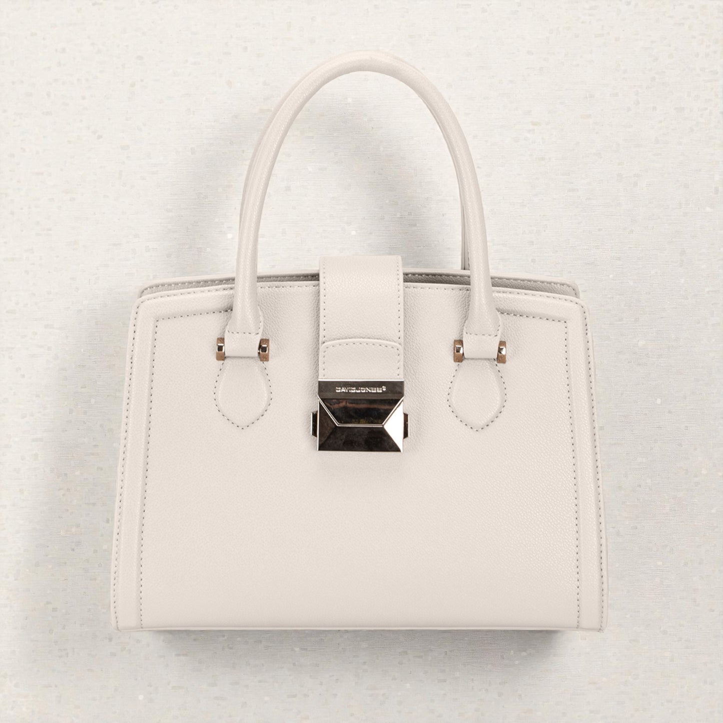 White handbag with a brand logo on a light gray background