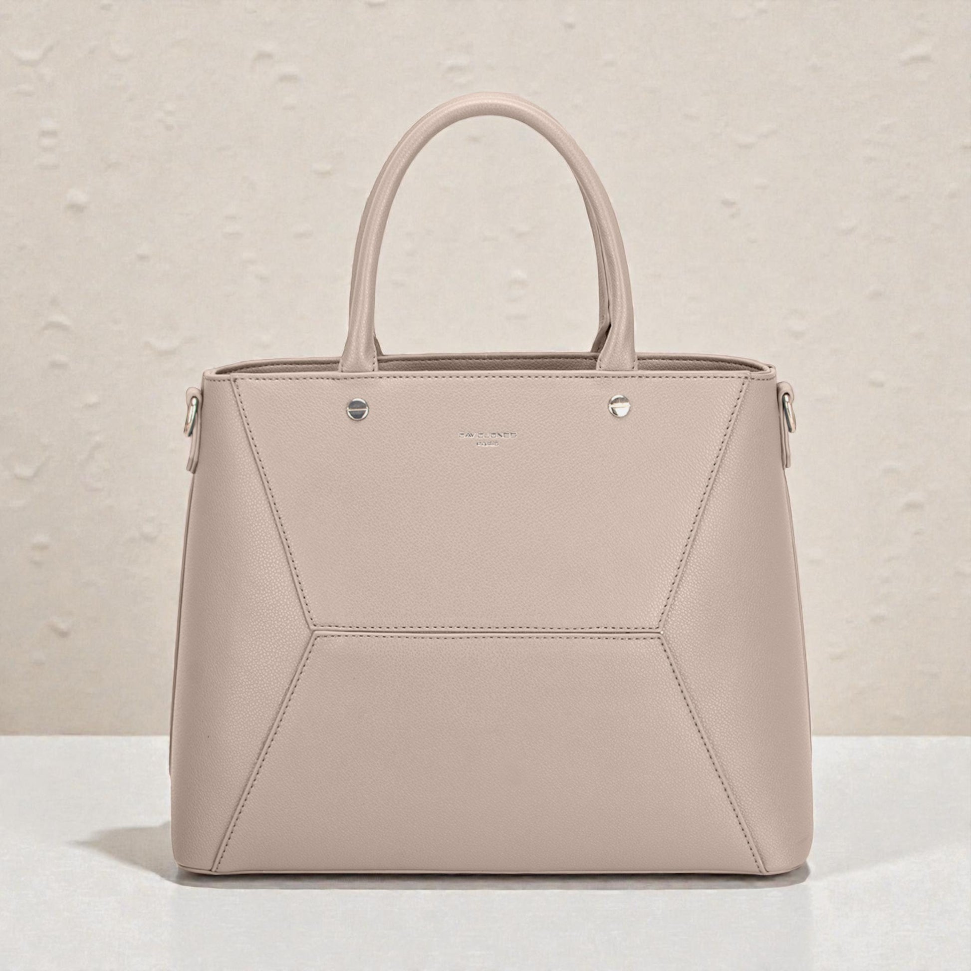 Beige handbag with geometric design on a light background