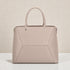 Beige handbag with geometric design on a light background