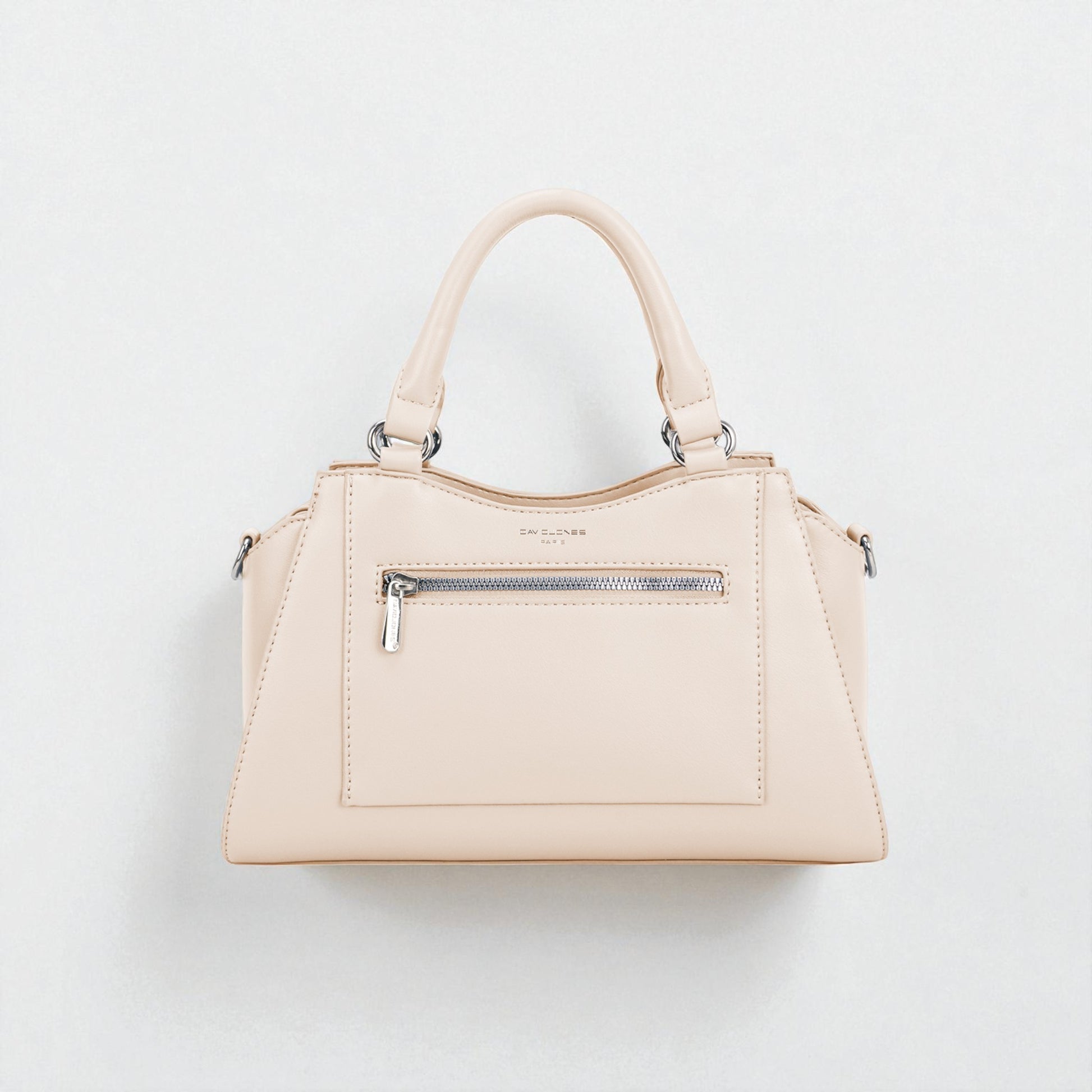 Beige handbag with silver zippers on a light gray background