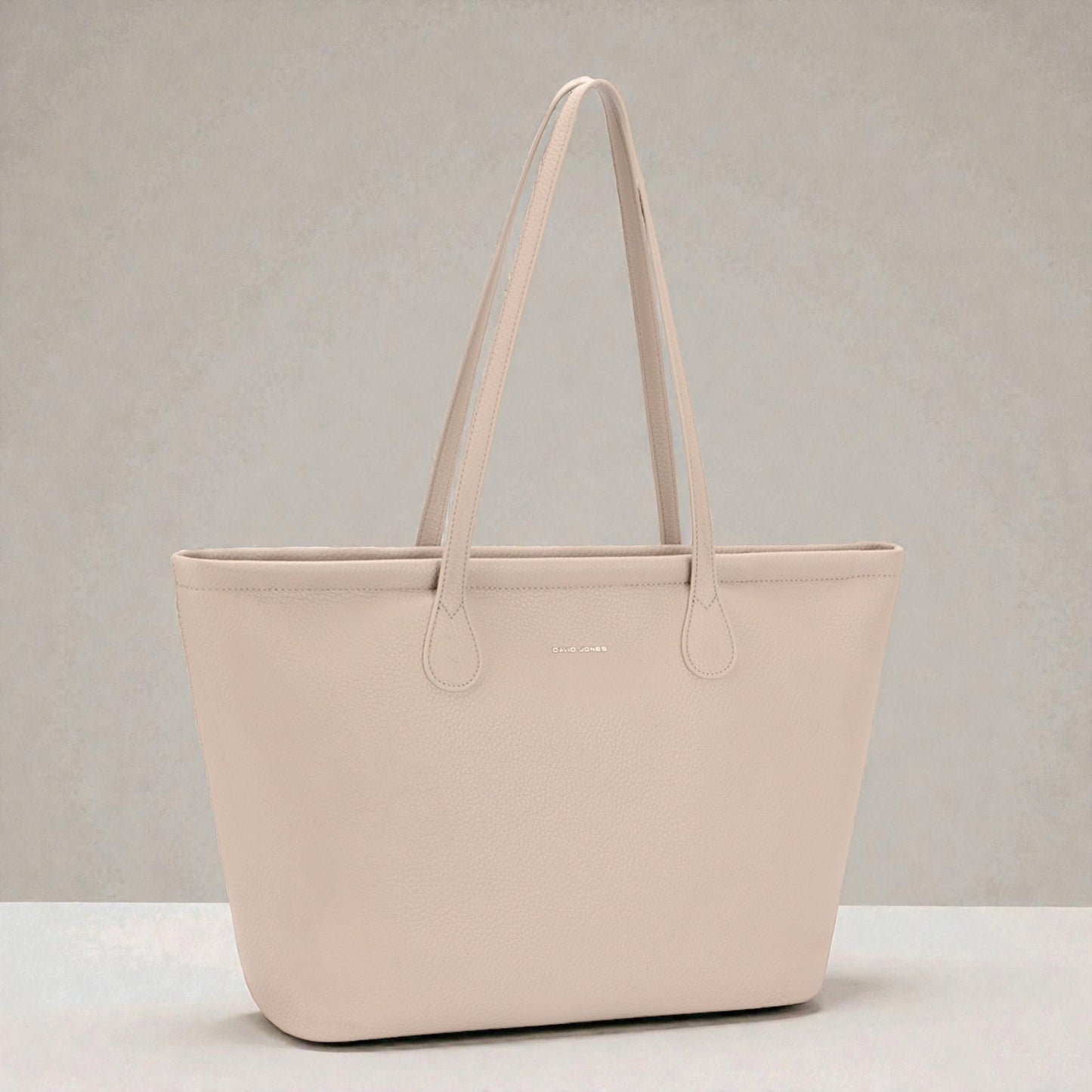 Beige tote bag on a light gray background
