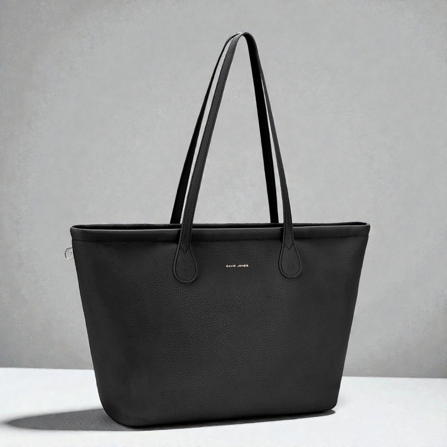 Black tote bag on a gray background