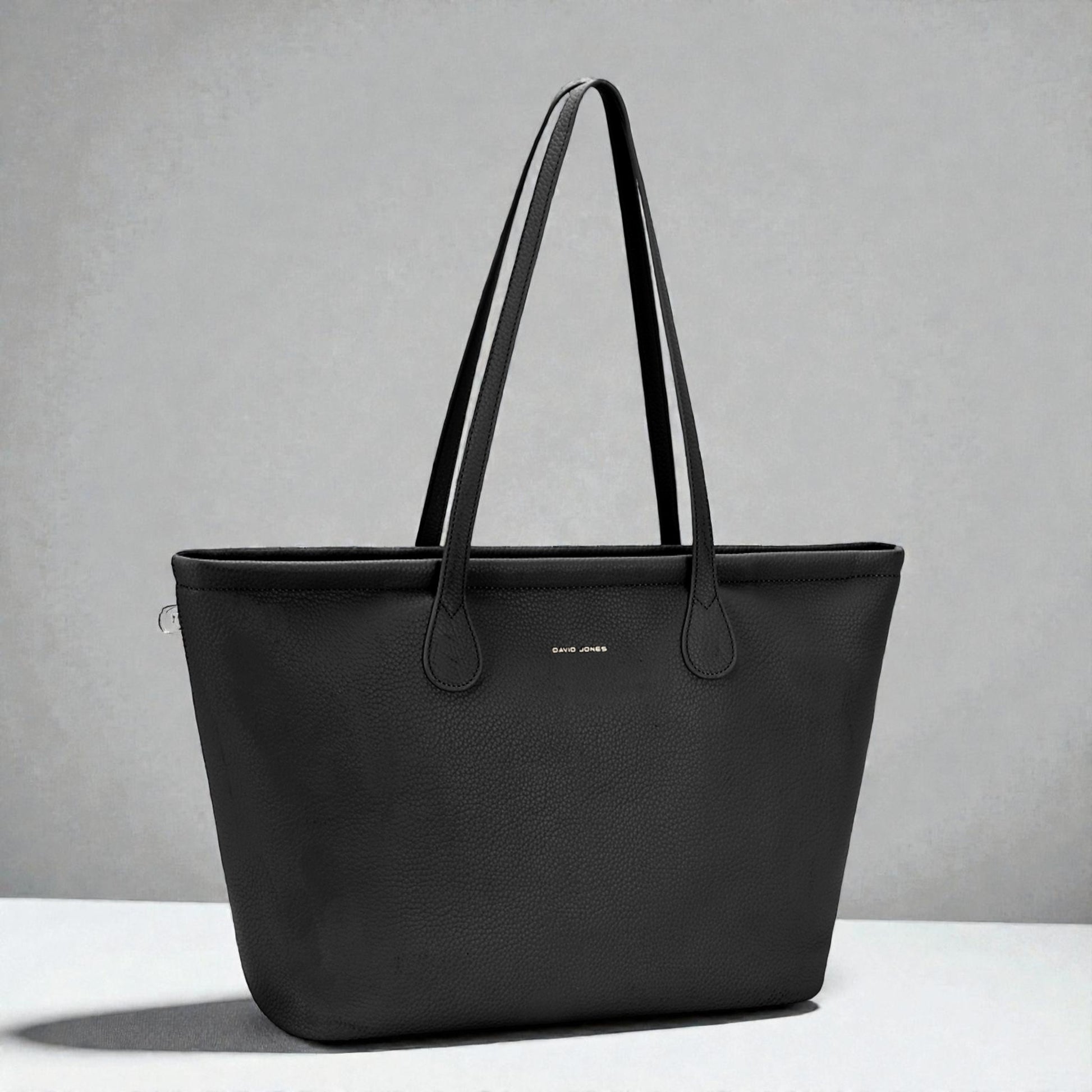 Black tote bag on a gray background