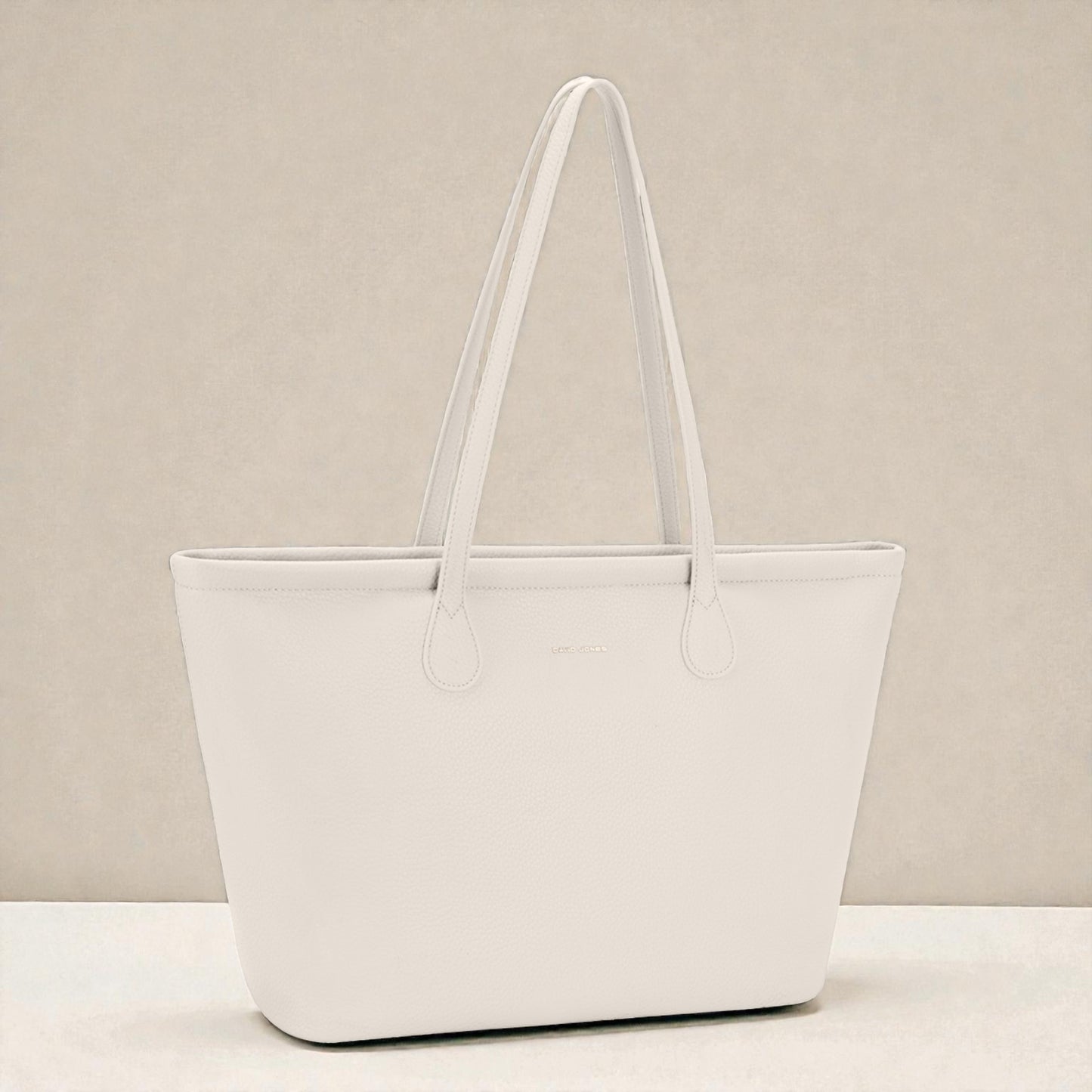 White tote bag on a beige background