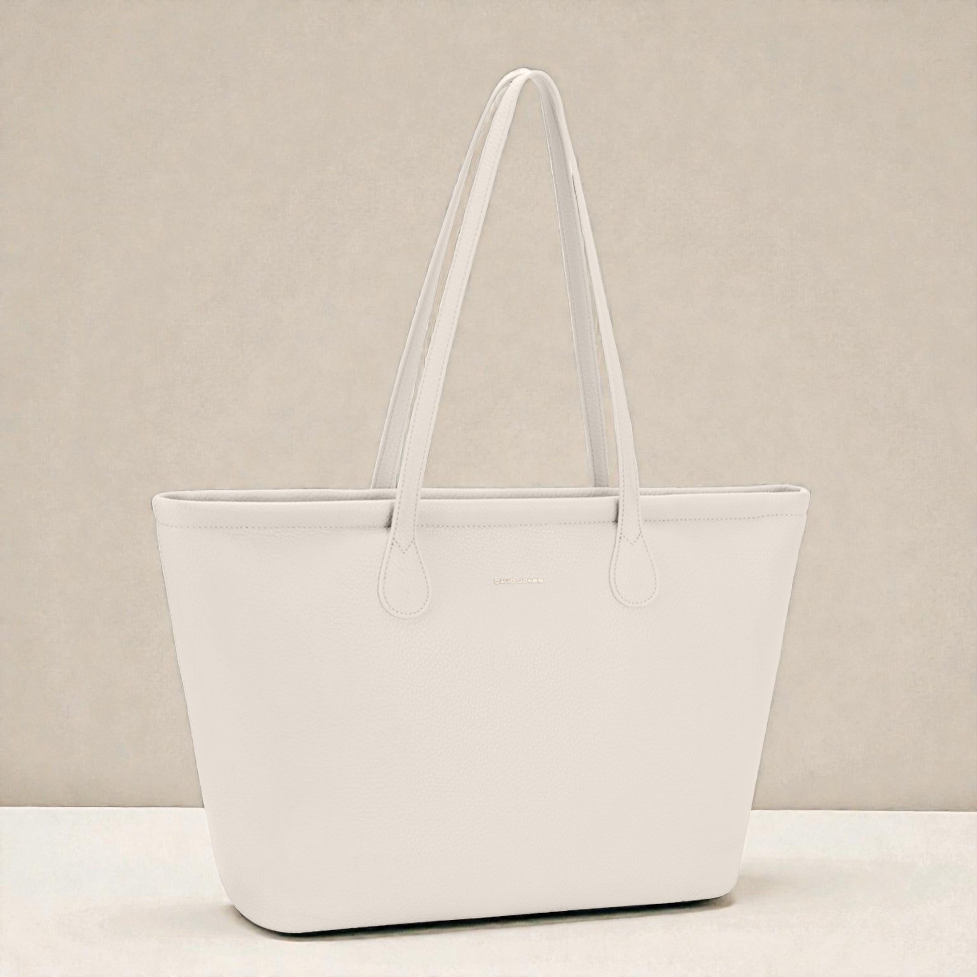 White tote bag on a beige background