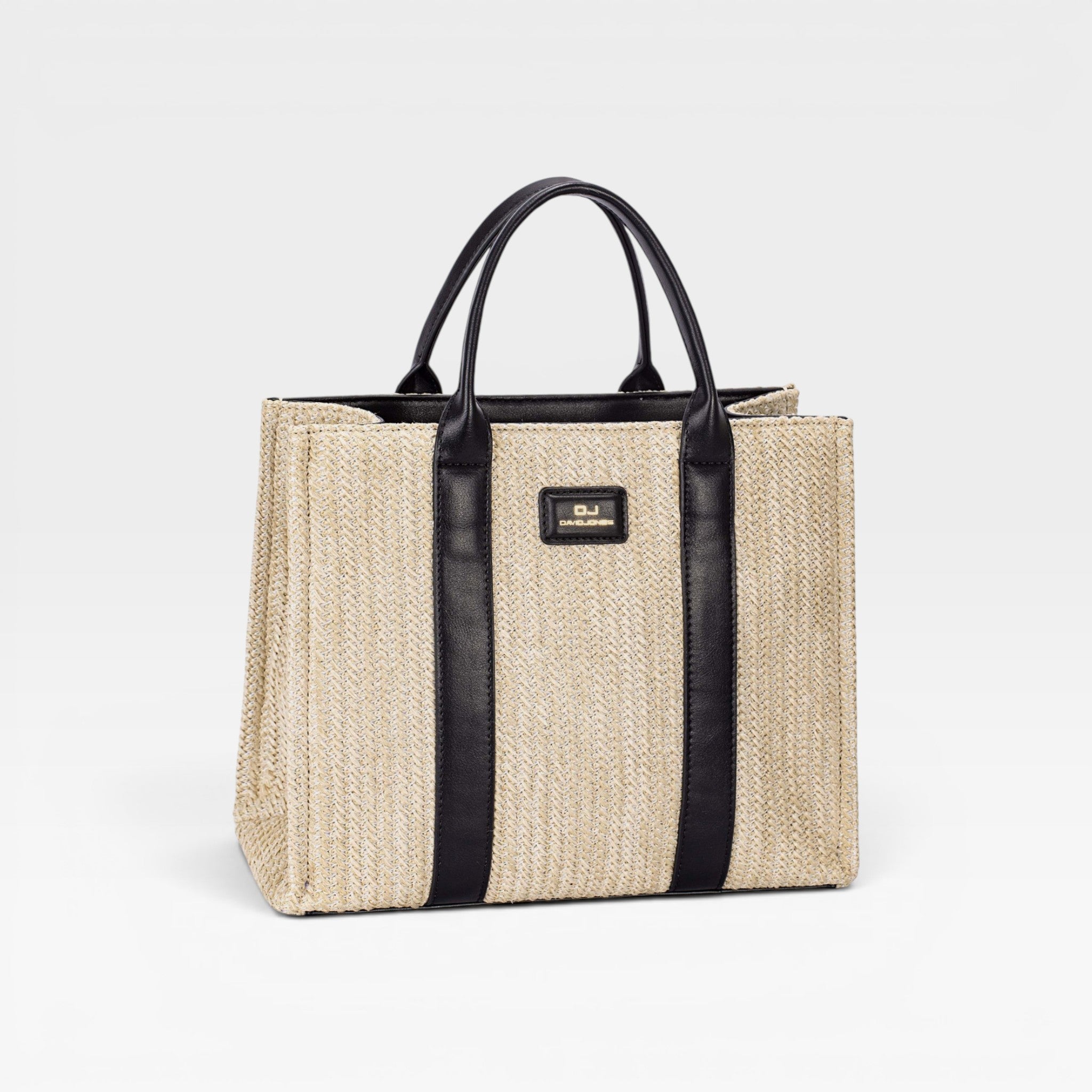 Beige straw tote bag with black straps on a light gray background