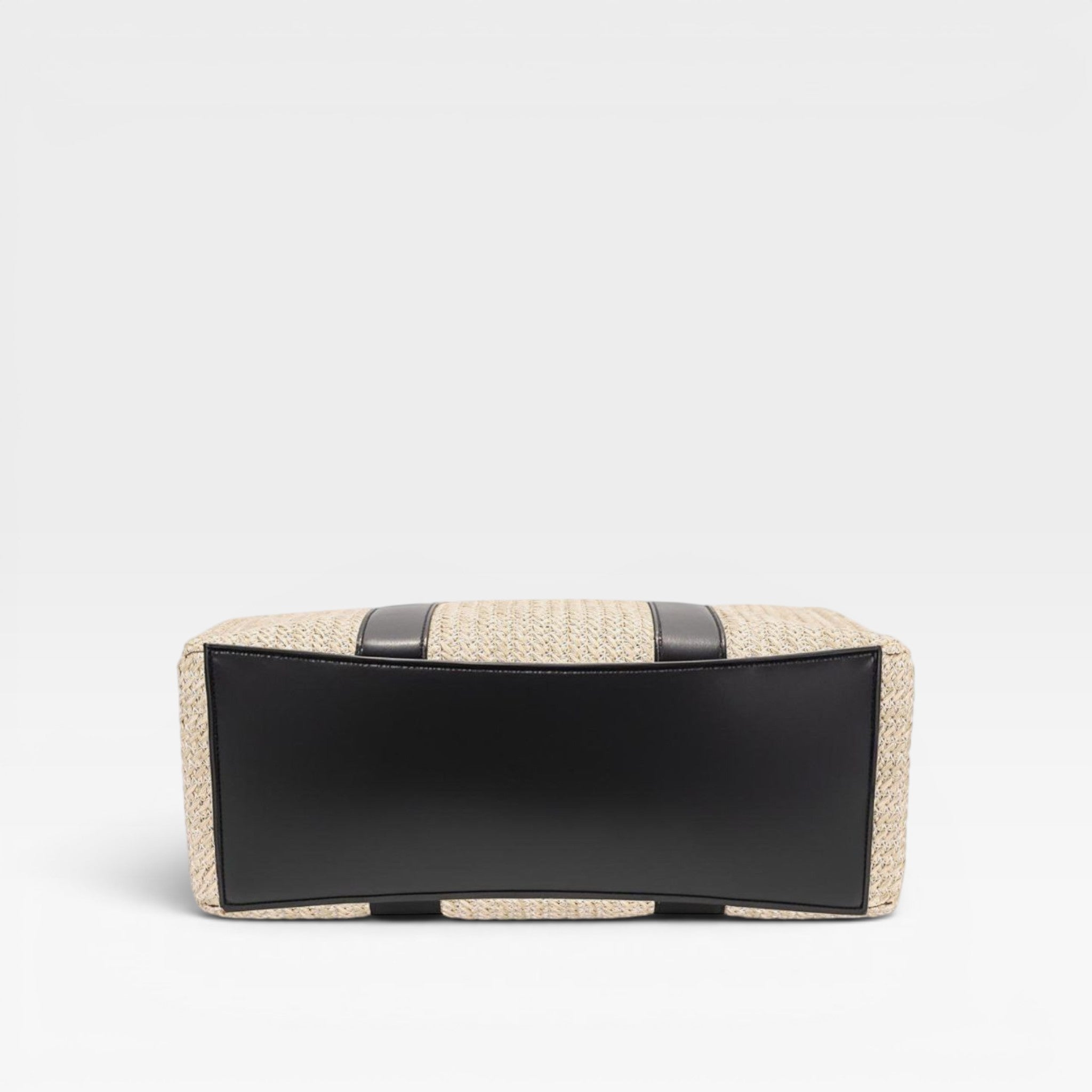 Clutch bag with woven design and black accents on a white background