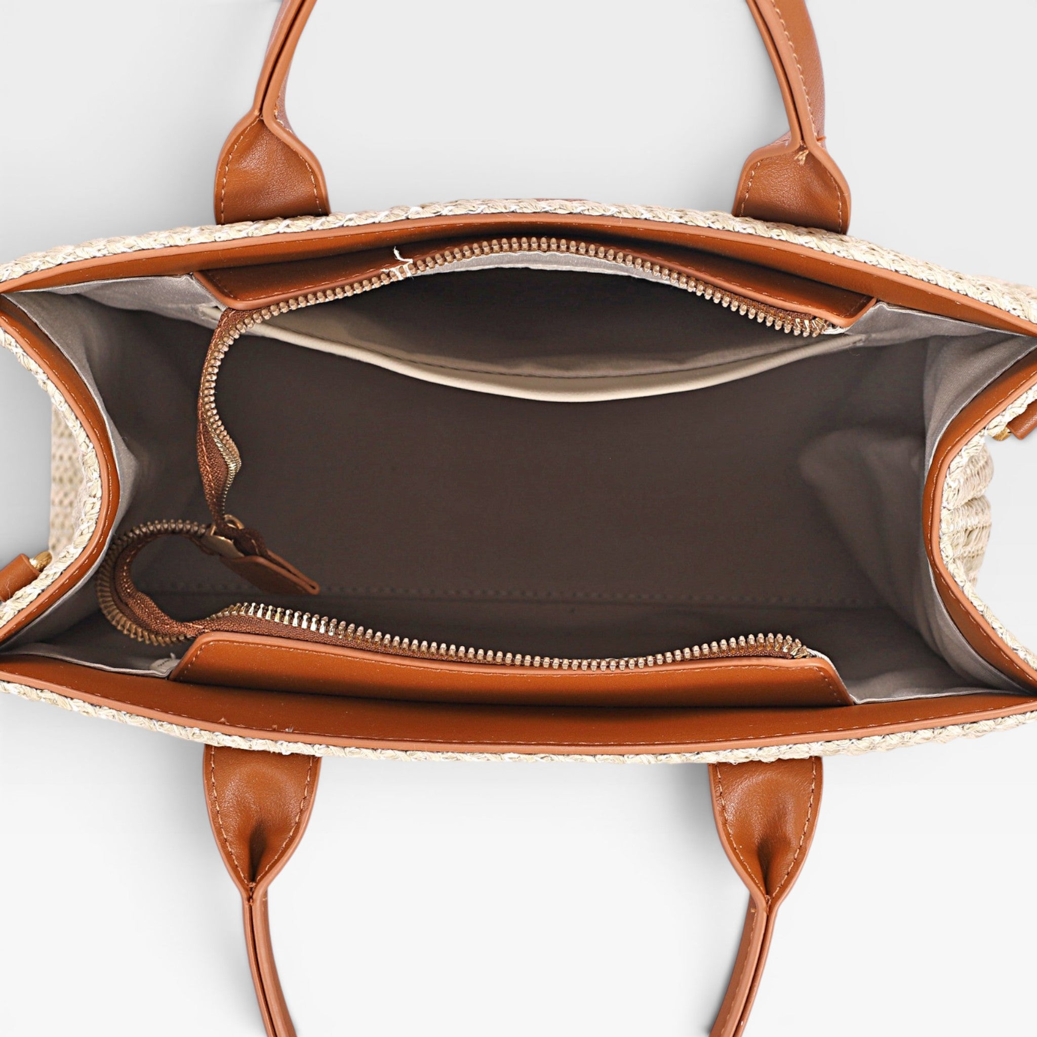 Brown leather handbag with open front pocket on a light gray background