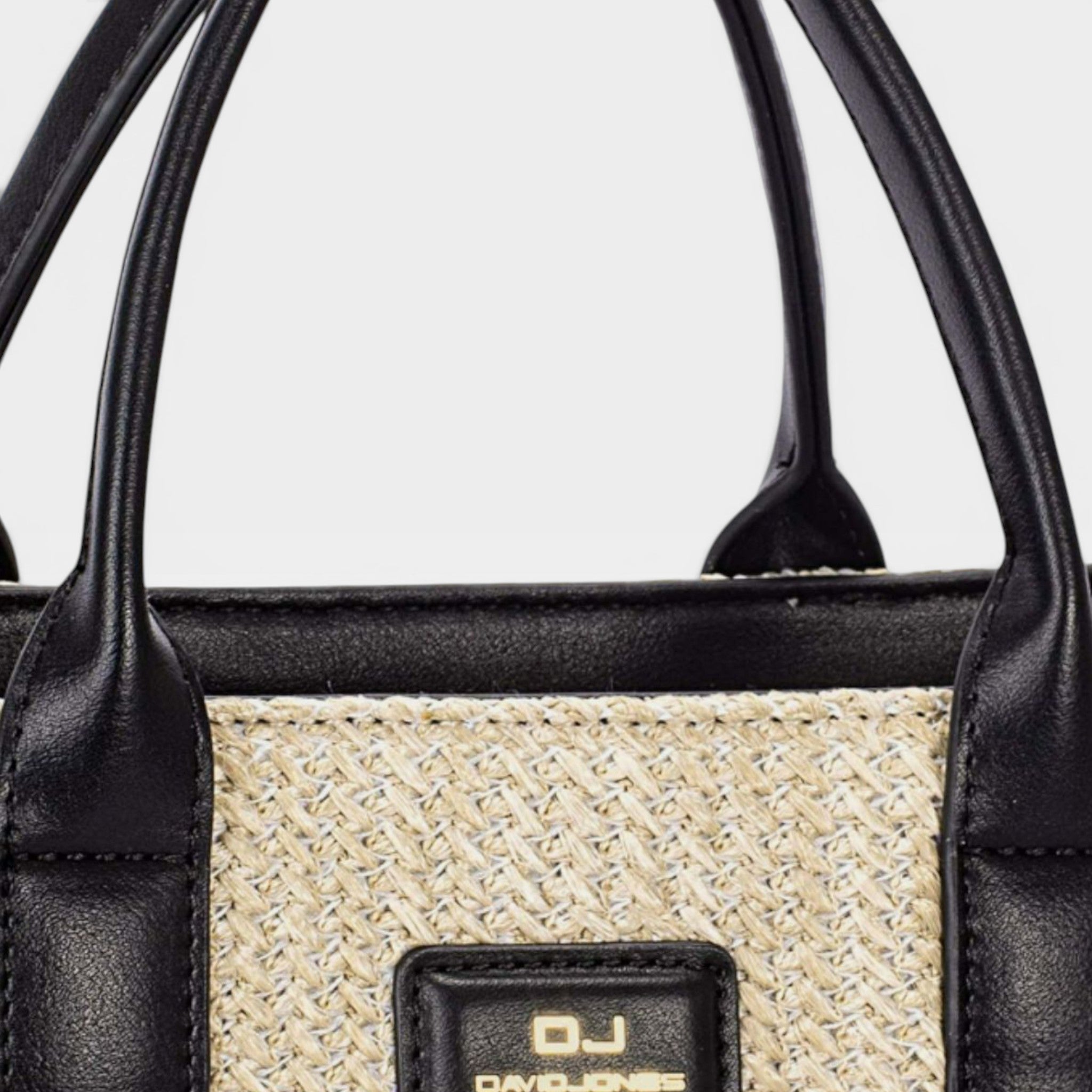 Black handbag with woven pattern and 'DJ' logo on a white background