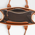 Brown leather handbag with open front pocket on a light gray background