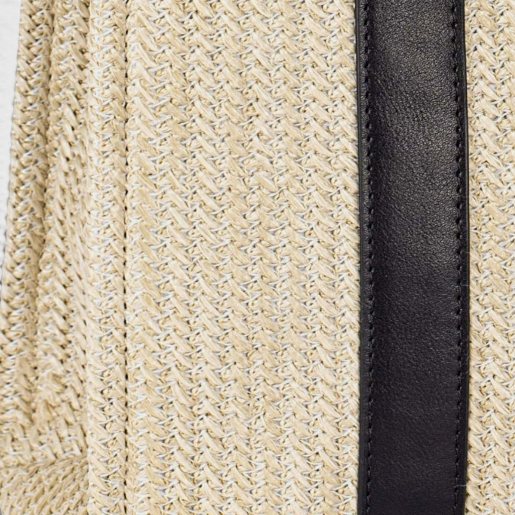 Close-up of beige textured fabric with a black strip
