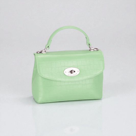 Green handbag with a silver clasp on a light gray background