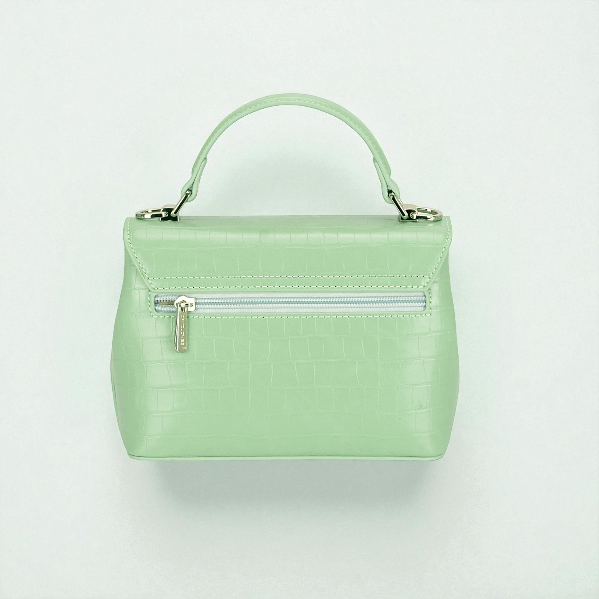 Mint green handbag with a silver zipper on a light gray background