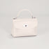 White handbag with a silver clasp on a light gray background