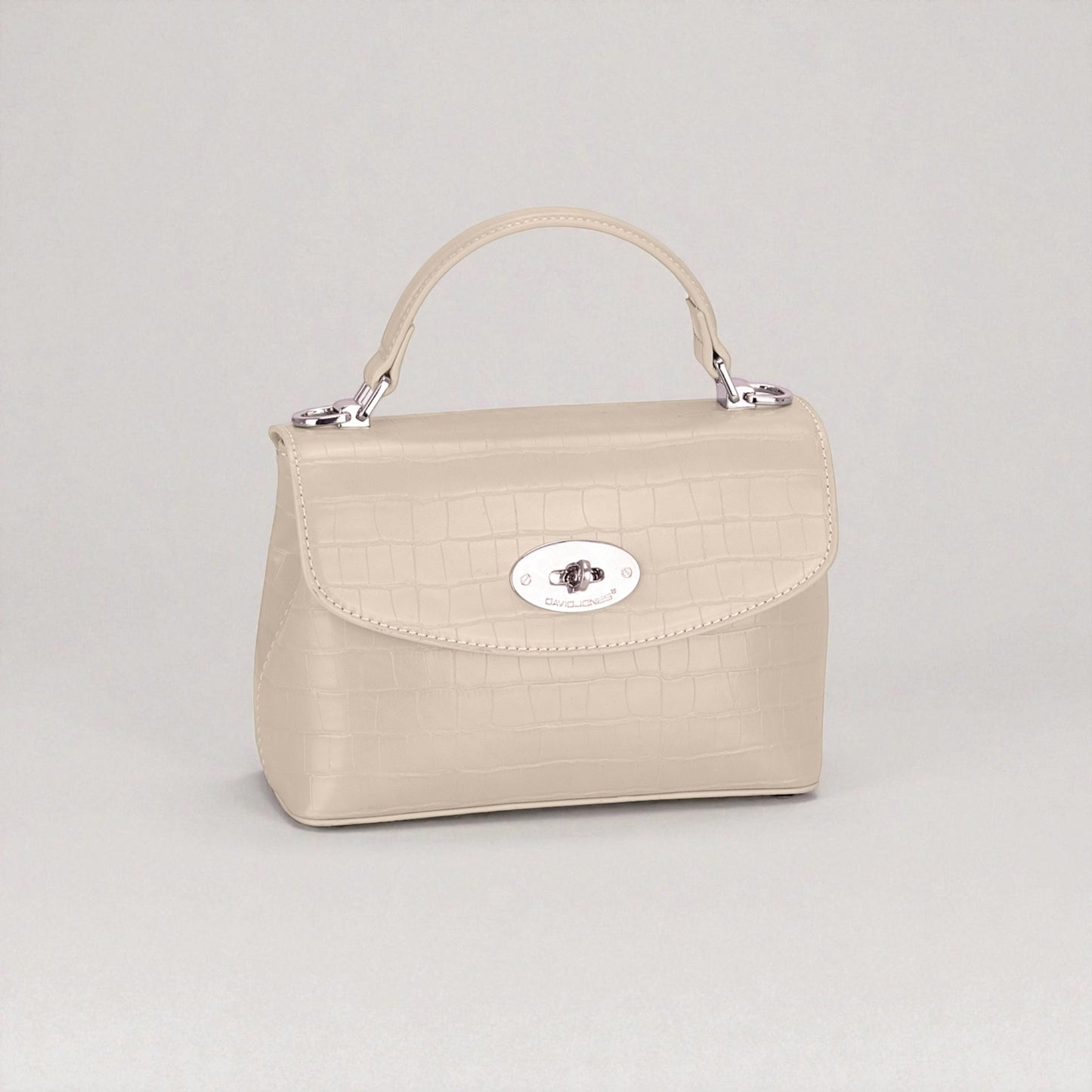 Beige handbag with a silver clasp on a light gray background