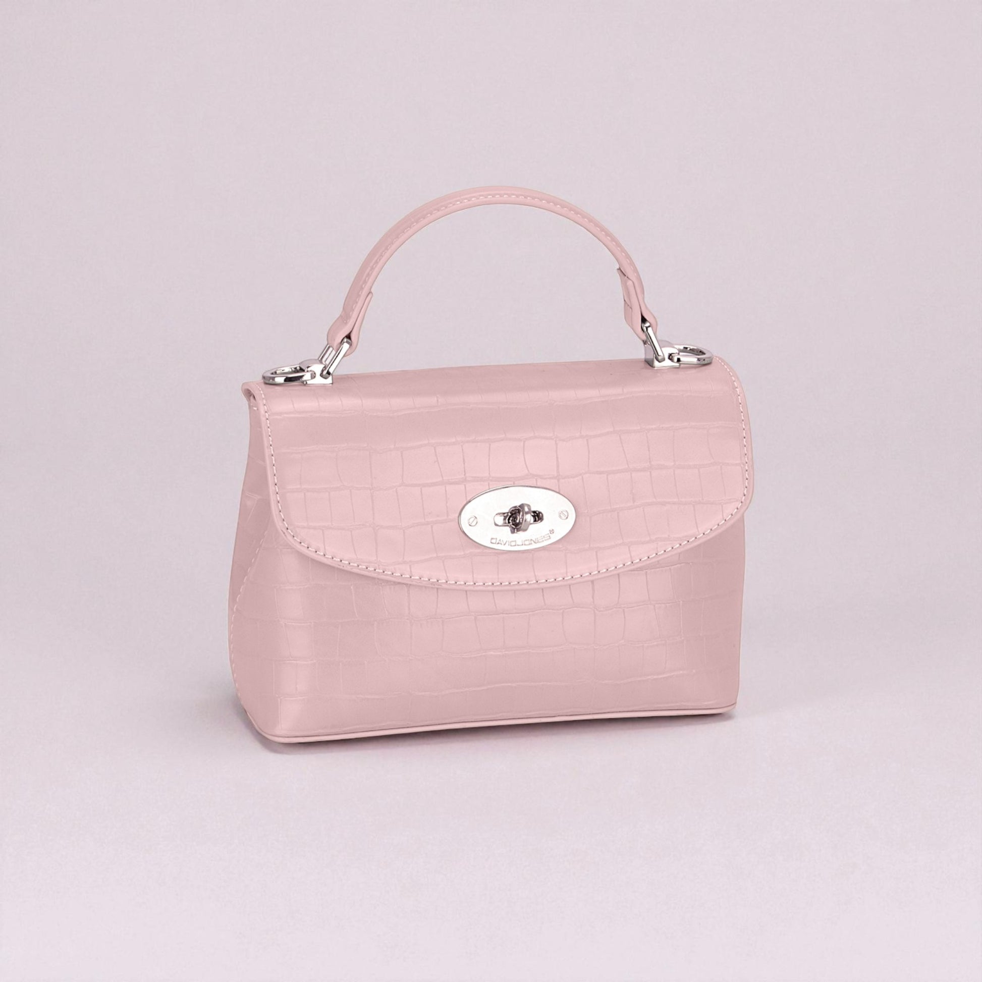 Pink handbag with a silver clasp on a light gray background