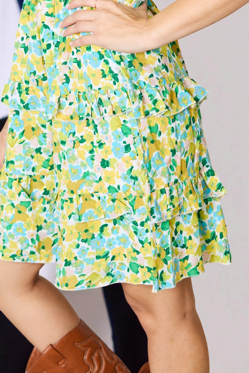 Floral patterned skirt worn by a person on a plain background