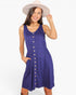 A woman wearing a sleeveless royal blue midi dress with a button-down front and a matching fabric belt, styled with a beige wide-brim hat against a plain white background.