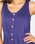Close-up of a sleeveless purple dress with a V-neck, button-front detail, and gathered waistband, shown on a model against a light background.