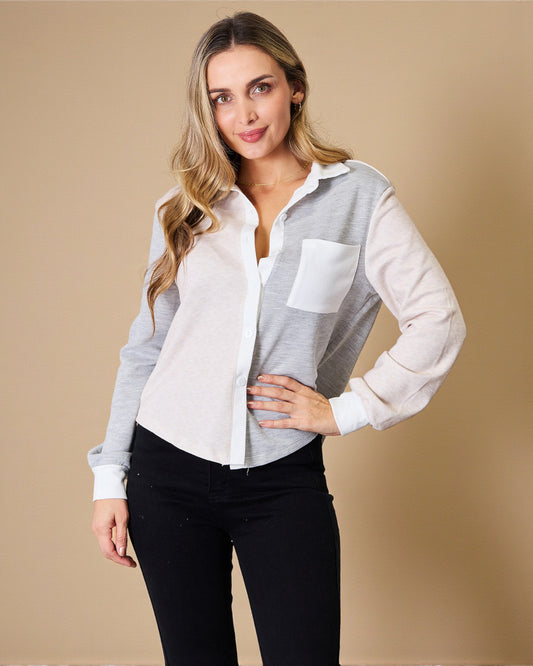 Woman wearing a light gray and white checkered shirt with a pocket on a beige background