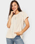 Woman wearing a beige blouse with lace details on a plain background