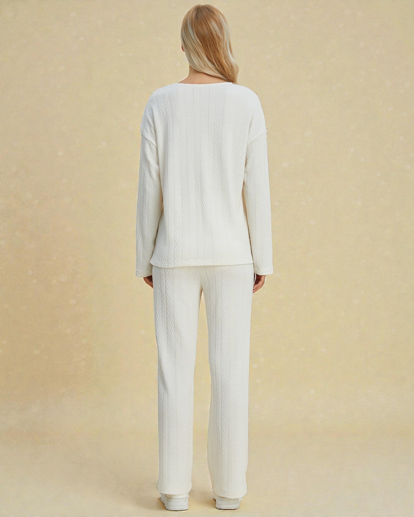 Person wearing a white outfit on a beige background