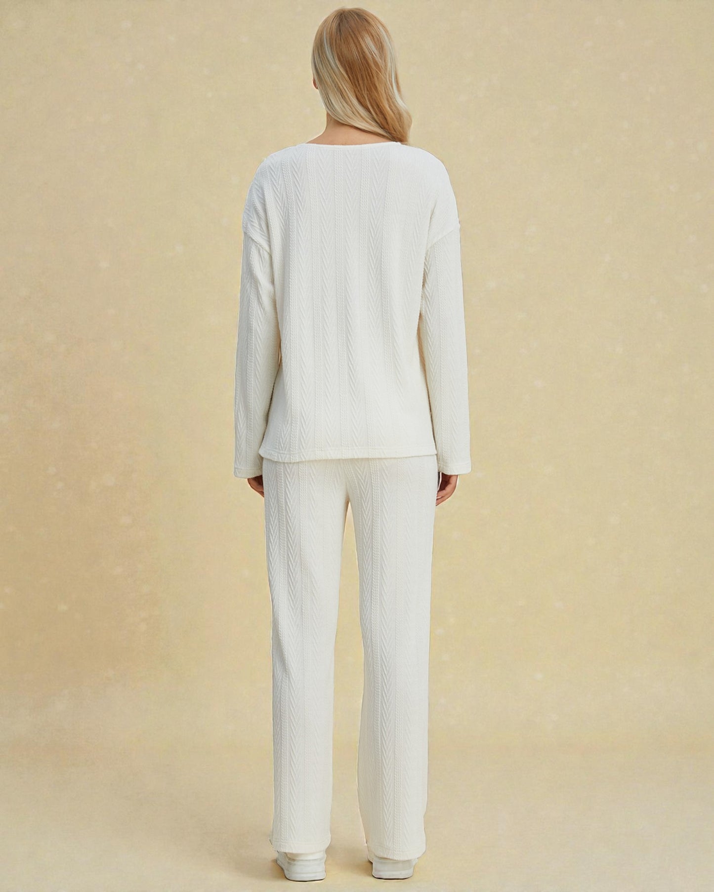 Person wearing a white outfit on a beige background