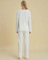 Person wearing a white outfit on a beige background