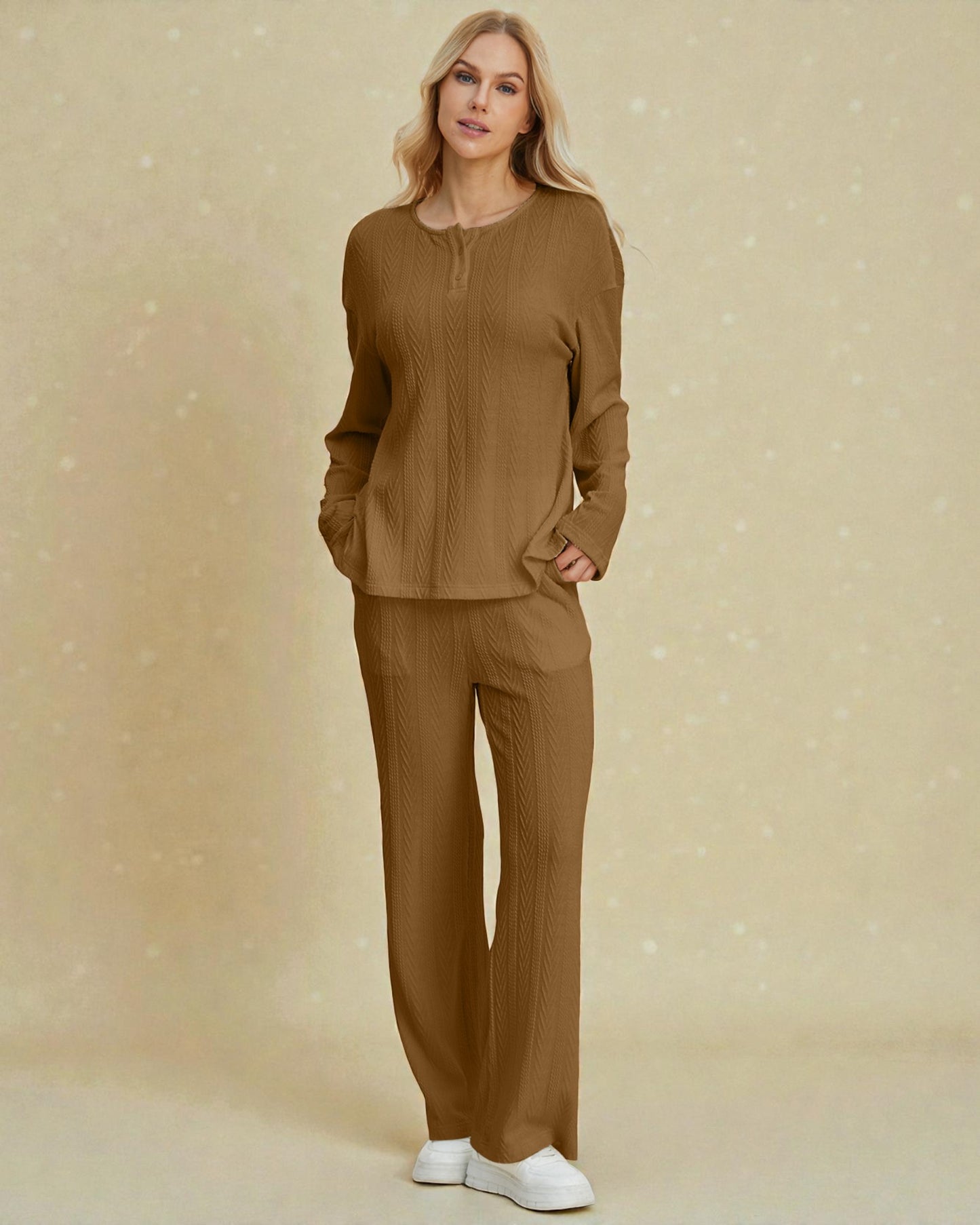 Woman wearing a brown outfit against a beige background