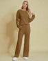 Woman wearing a brown outfit against a beige background