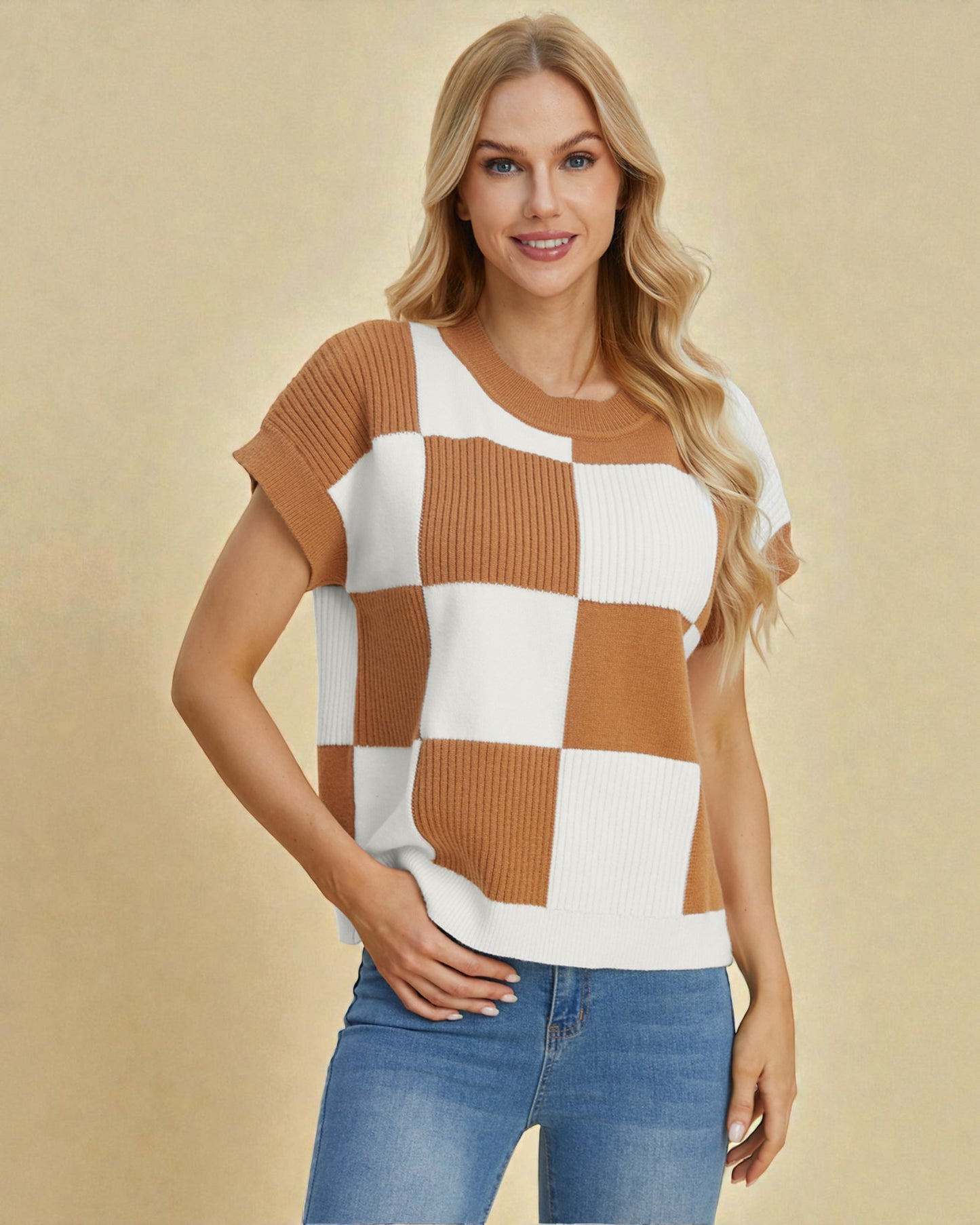 Woman wearing a checkered brown and white top with blue jeans on a beige background
