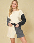 Woman wearing a two-tone sweater dress on a beige background
