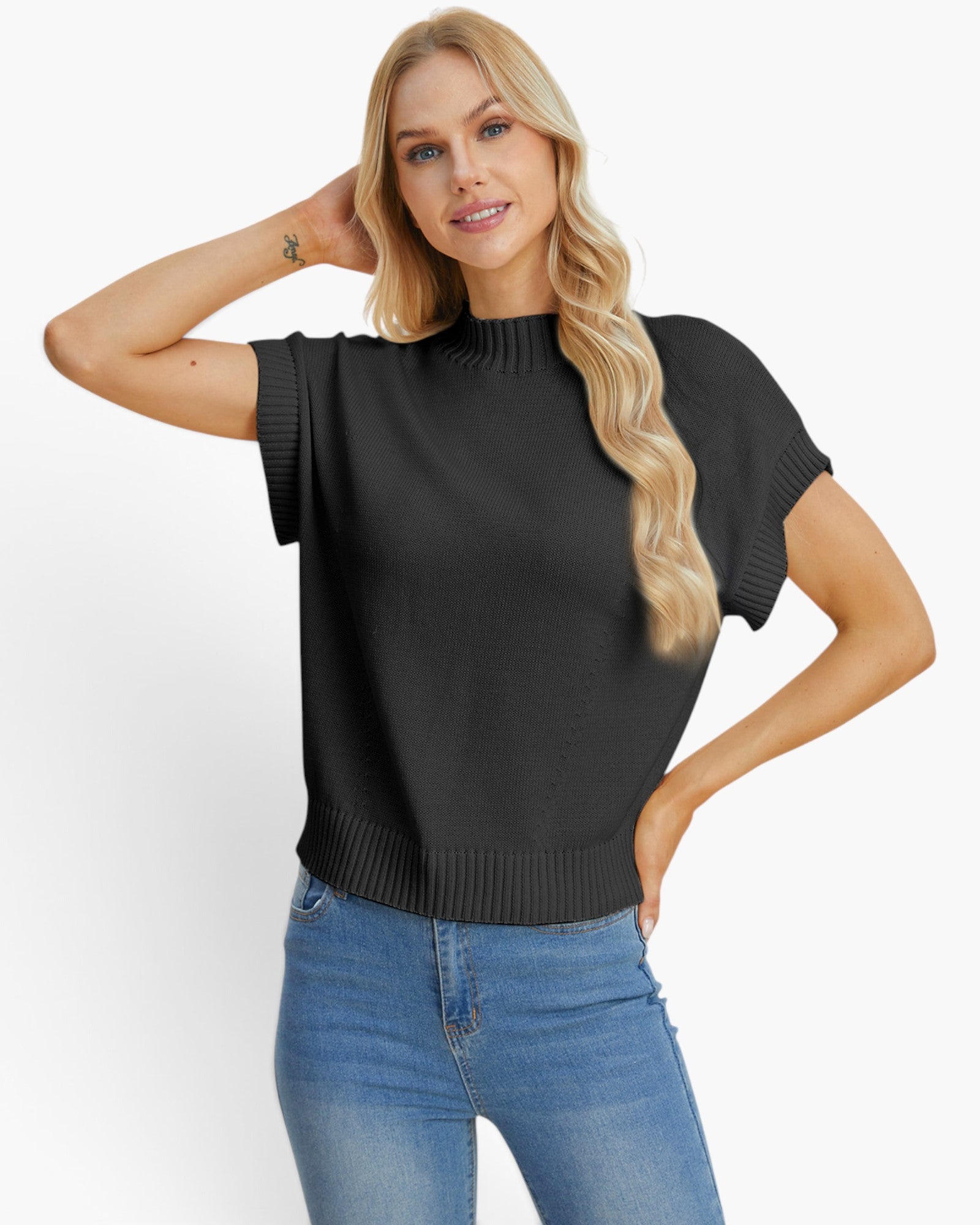 A blonde woman modeling a black short-sleeve mock neck knit top with ribbed trim, paired with blue jeans, against a plain white studio background.