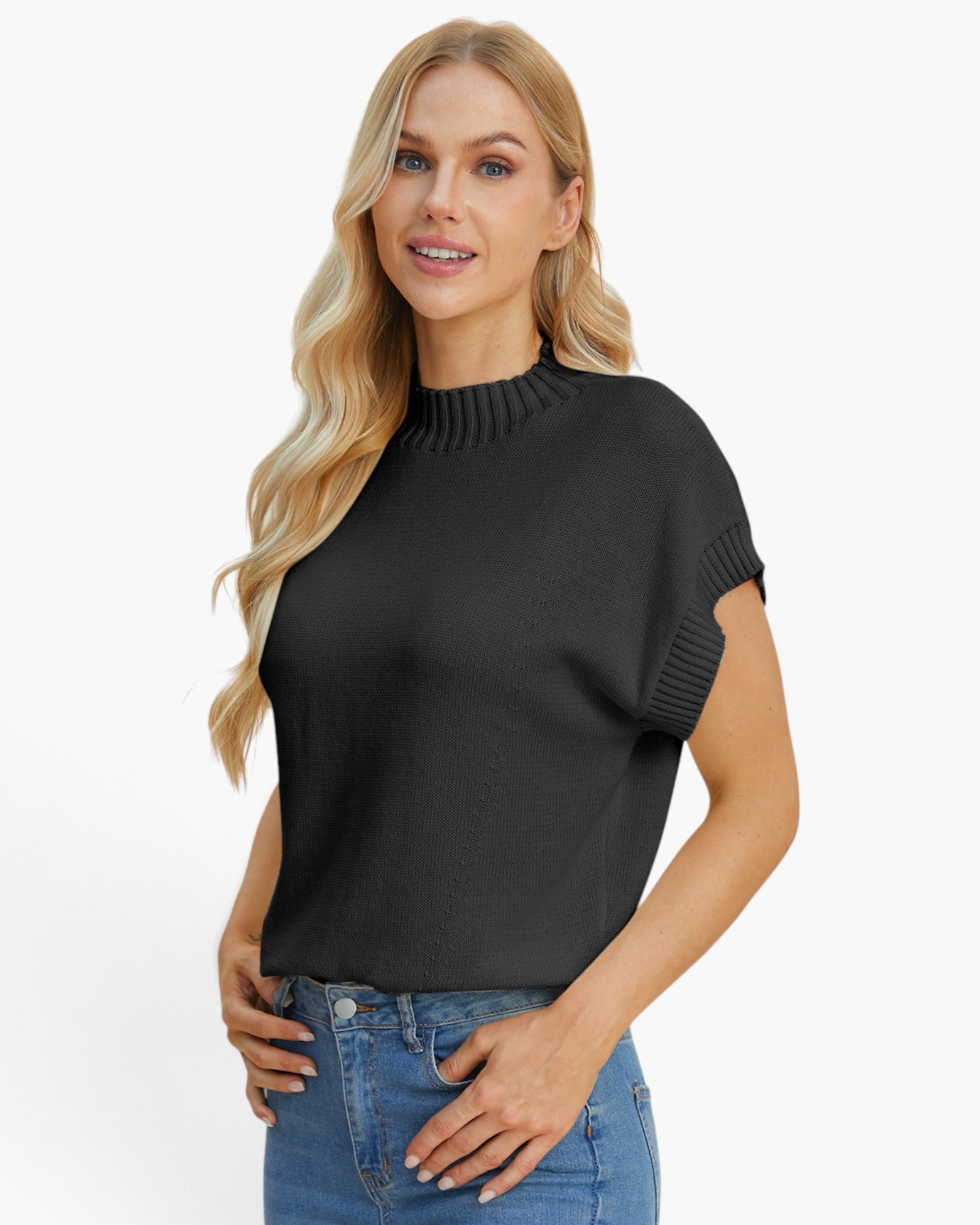 A blonde woman wearing a black short-sleeve mock neck knit top with ribbed sleeve cuffs, paired with blue jeans, against a plain white background.