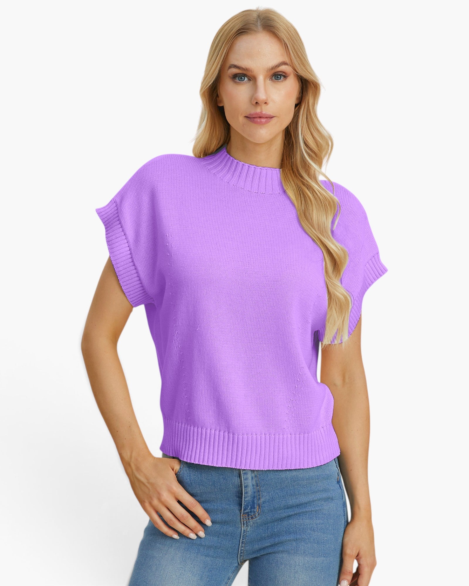 A woman modeling a light purple knit sweater with short cap sleeves and a ribbed crew neck, hem, and cuffs, paired with blue jeans against a plain white background.