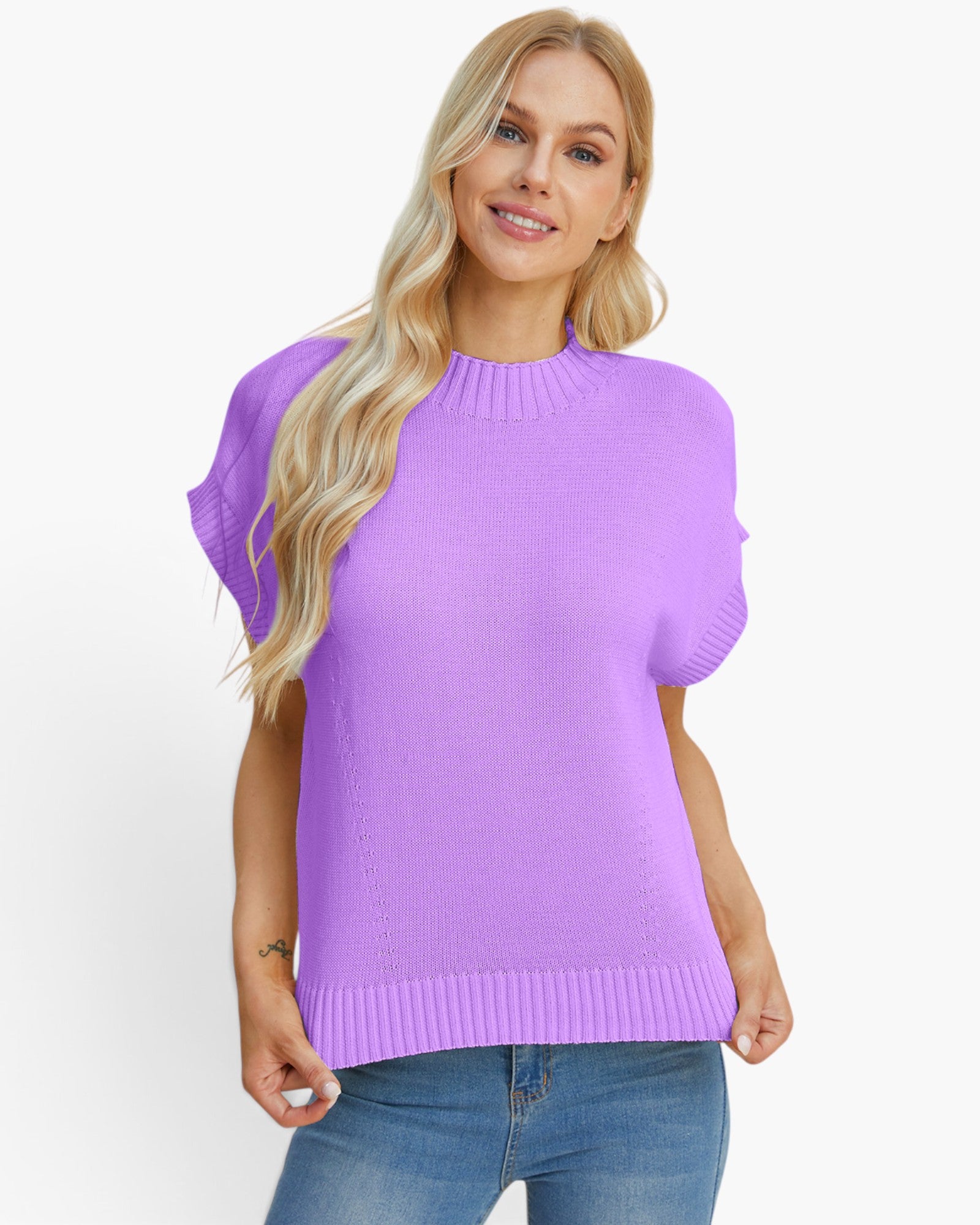 A woman modeling a short-sleeve knit sweater in light purple with blue jeans against a plain white background.
