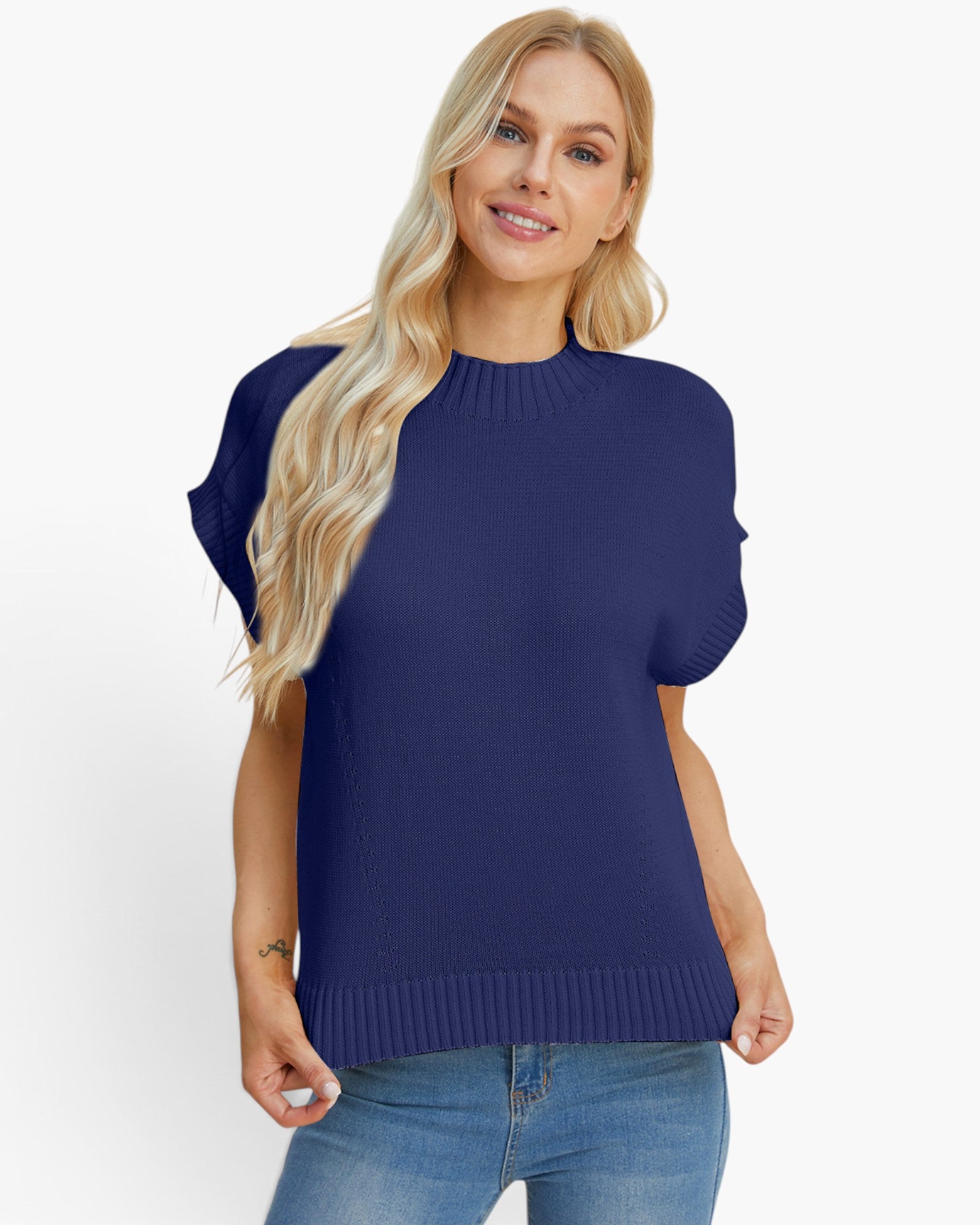 A woman modeling a navy blue short-sleeve knit sweater with a crew neck and ribbed hem, paired with blue jeans, against a plain white background.