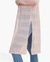 A light pink open-knit cardigan with horizontal textured stripes, shown worn over blue jeans against a plain white background.