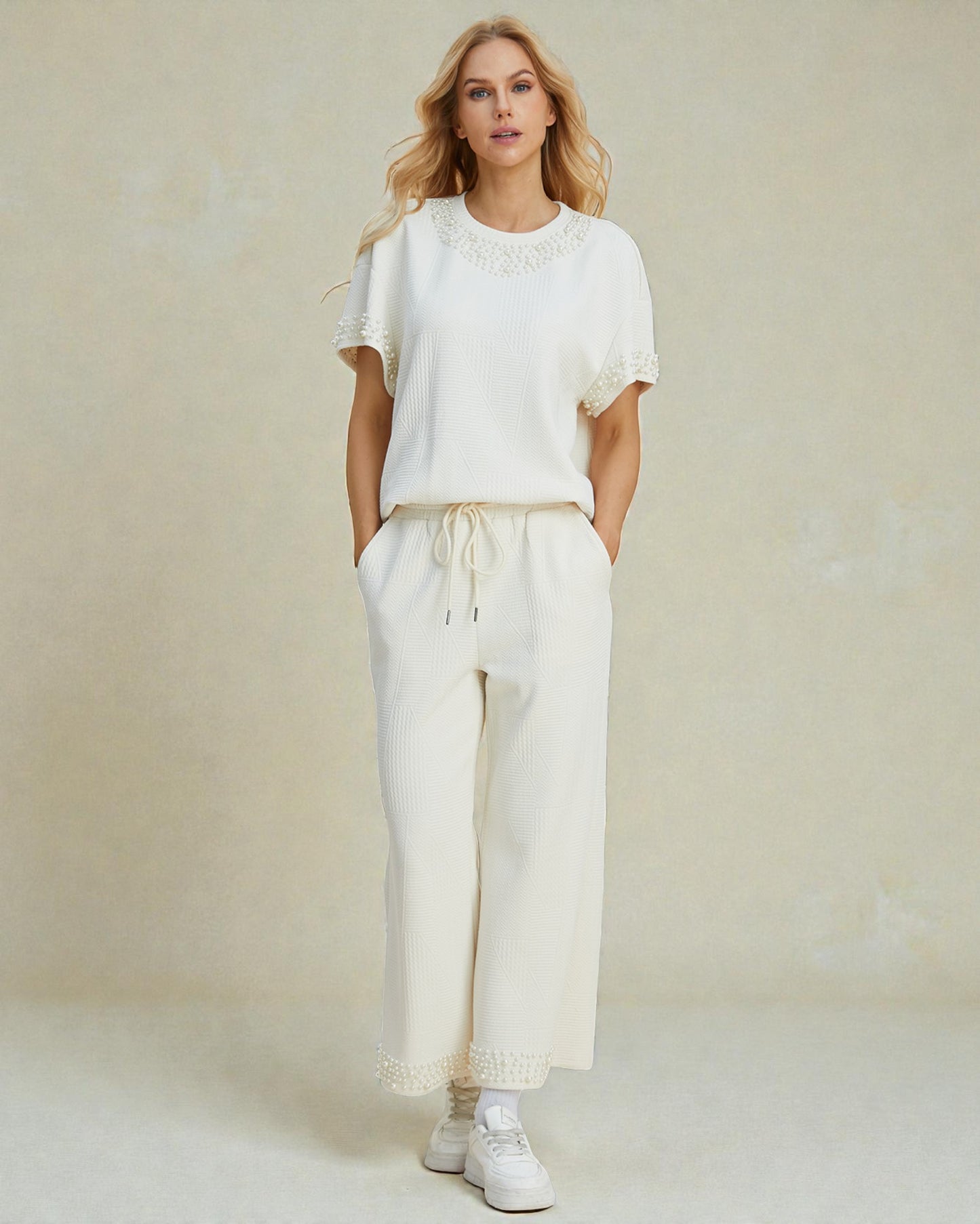 Woman wearing a white outfit with a plain background