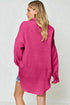 Woman wearing a pink oversized shirt against a white background