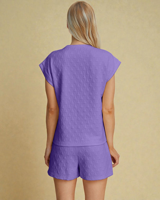 Person wearing a purple outfit on a beige background