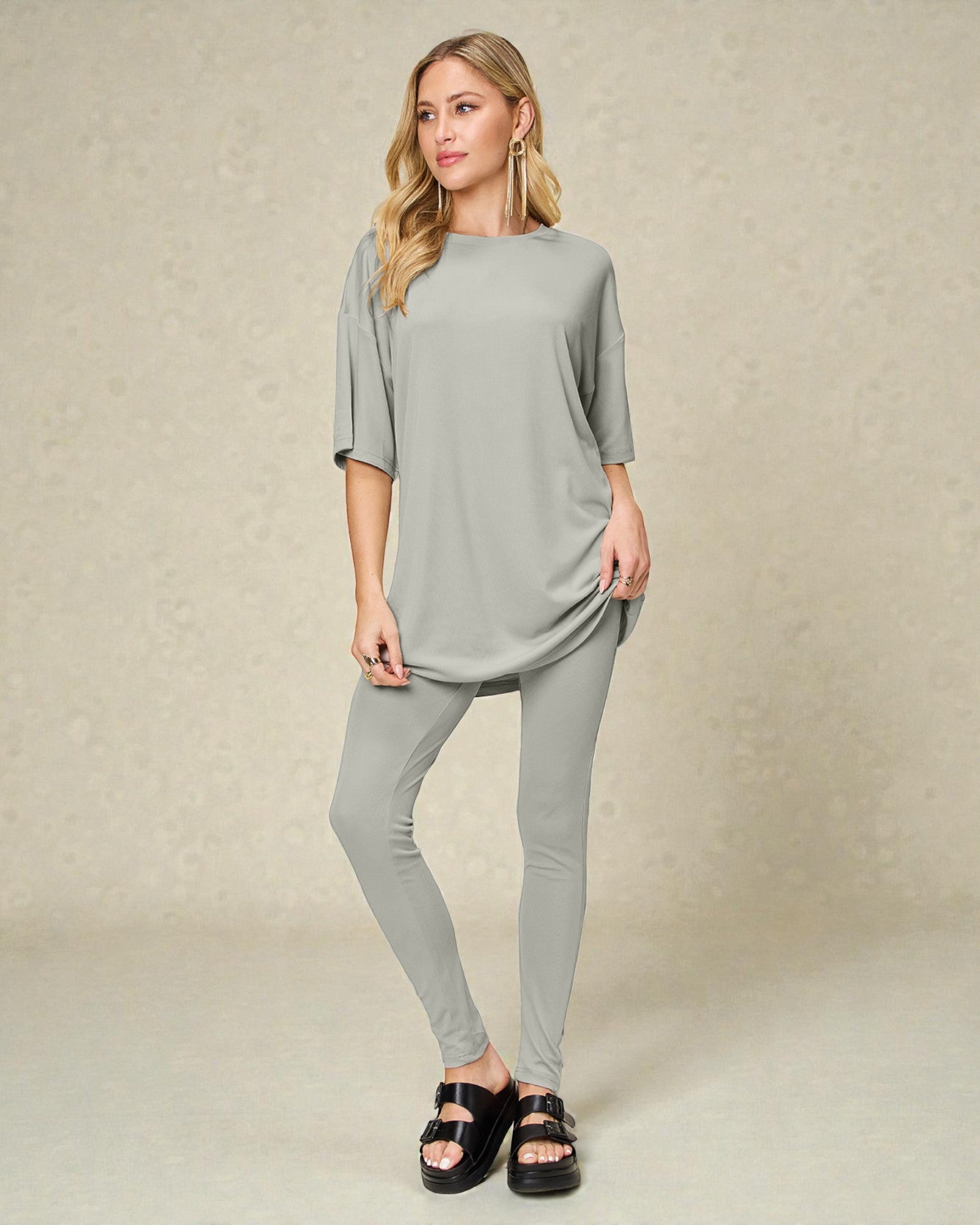 Woman wearing a gray outfit on a beige background