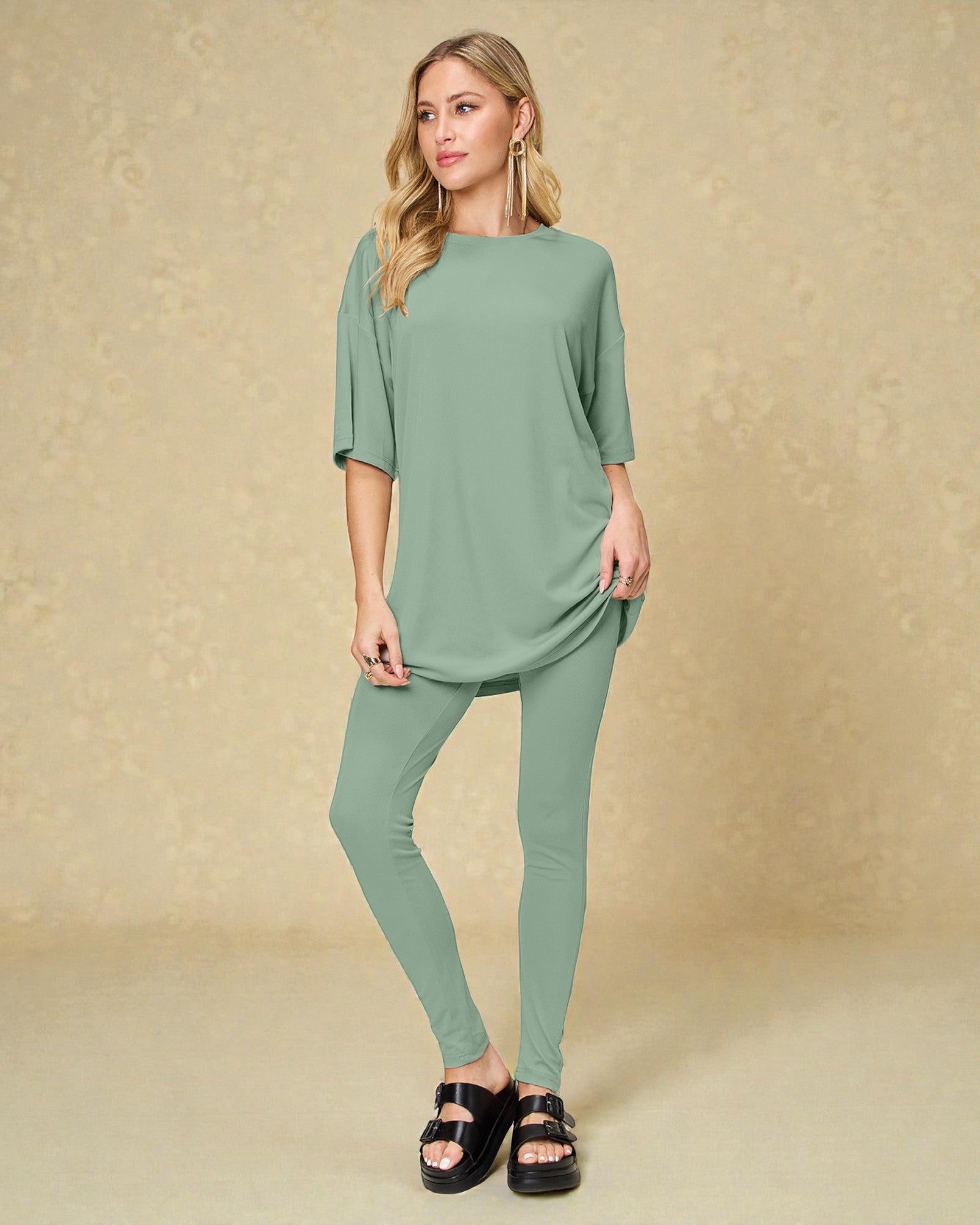 Woman wearing a green outfit against a beige background