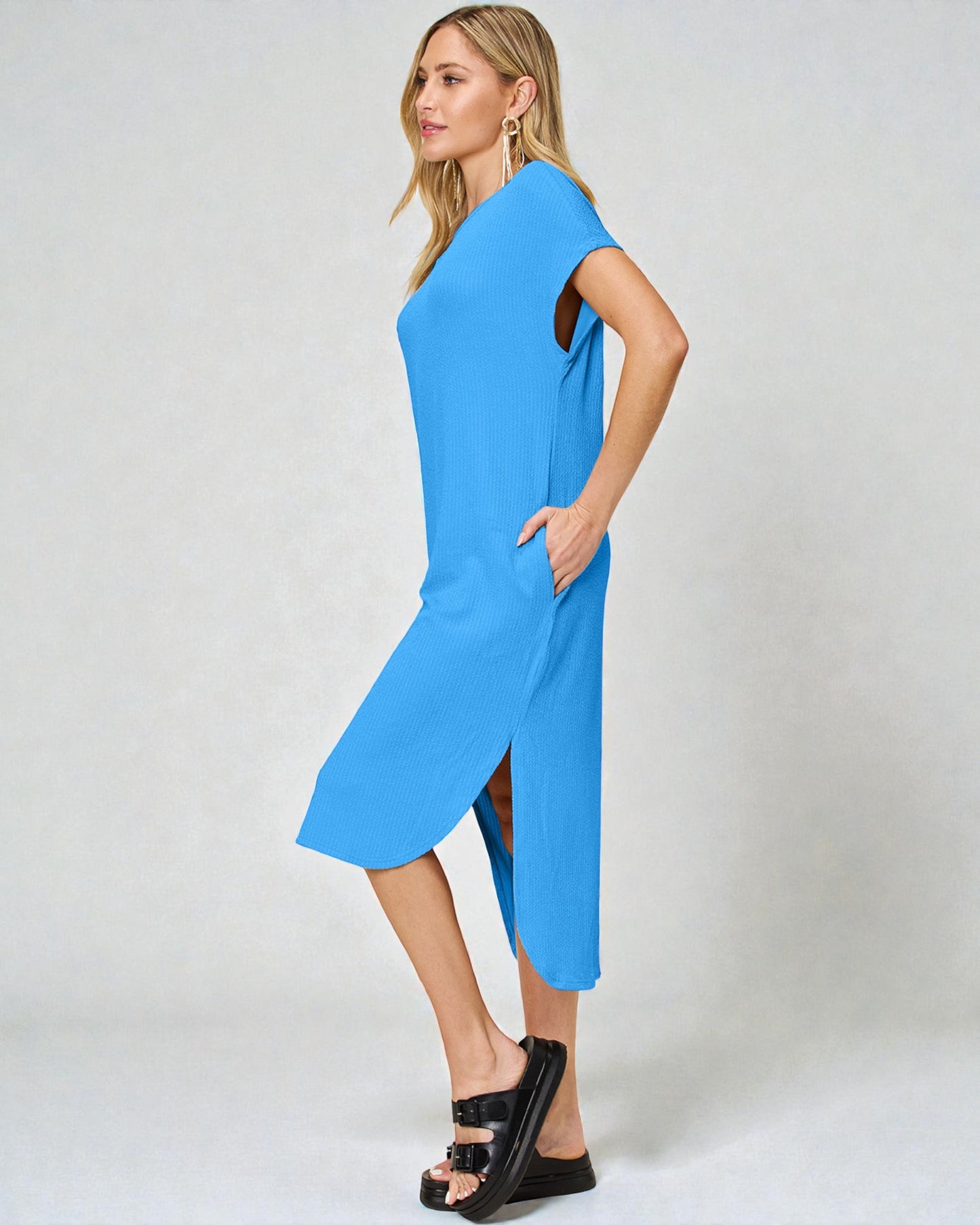 Woman wearing a blue dress with a white background