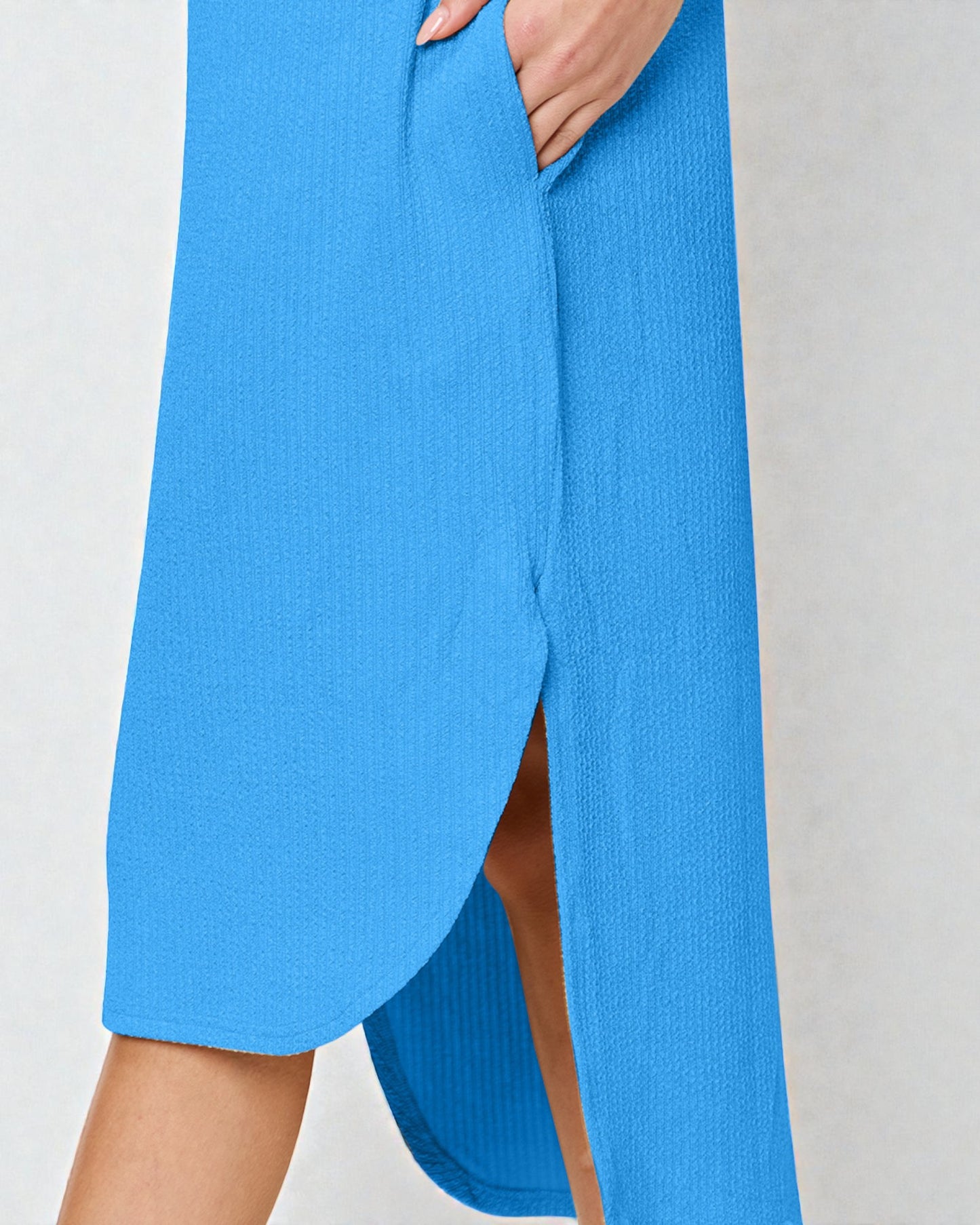 Blue dress with a slit on a plain background