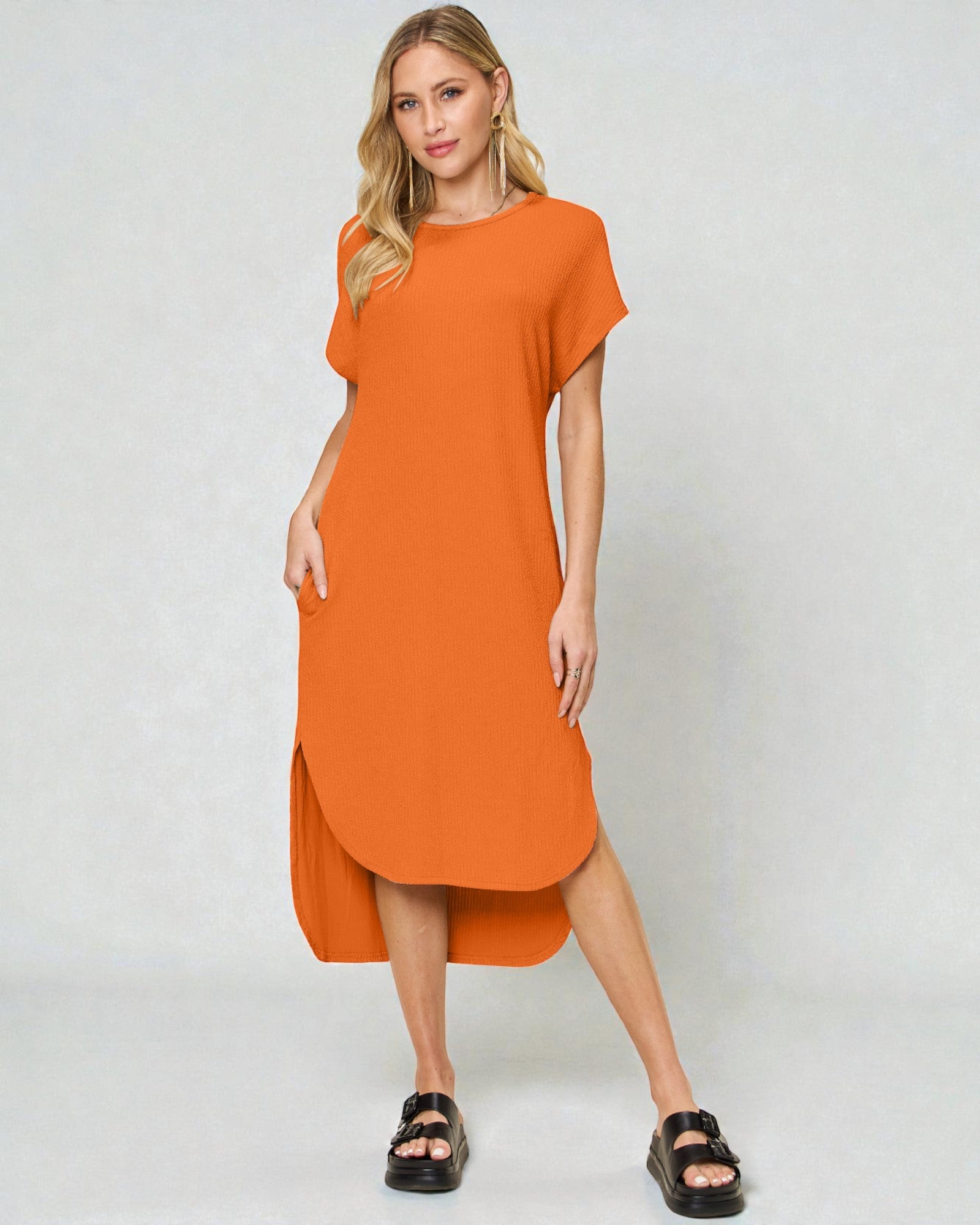 Woman wearing an orange dress on a white background