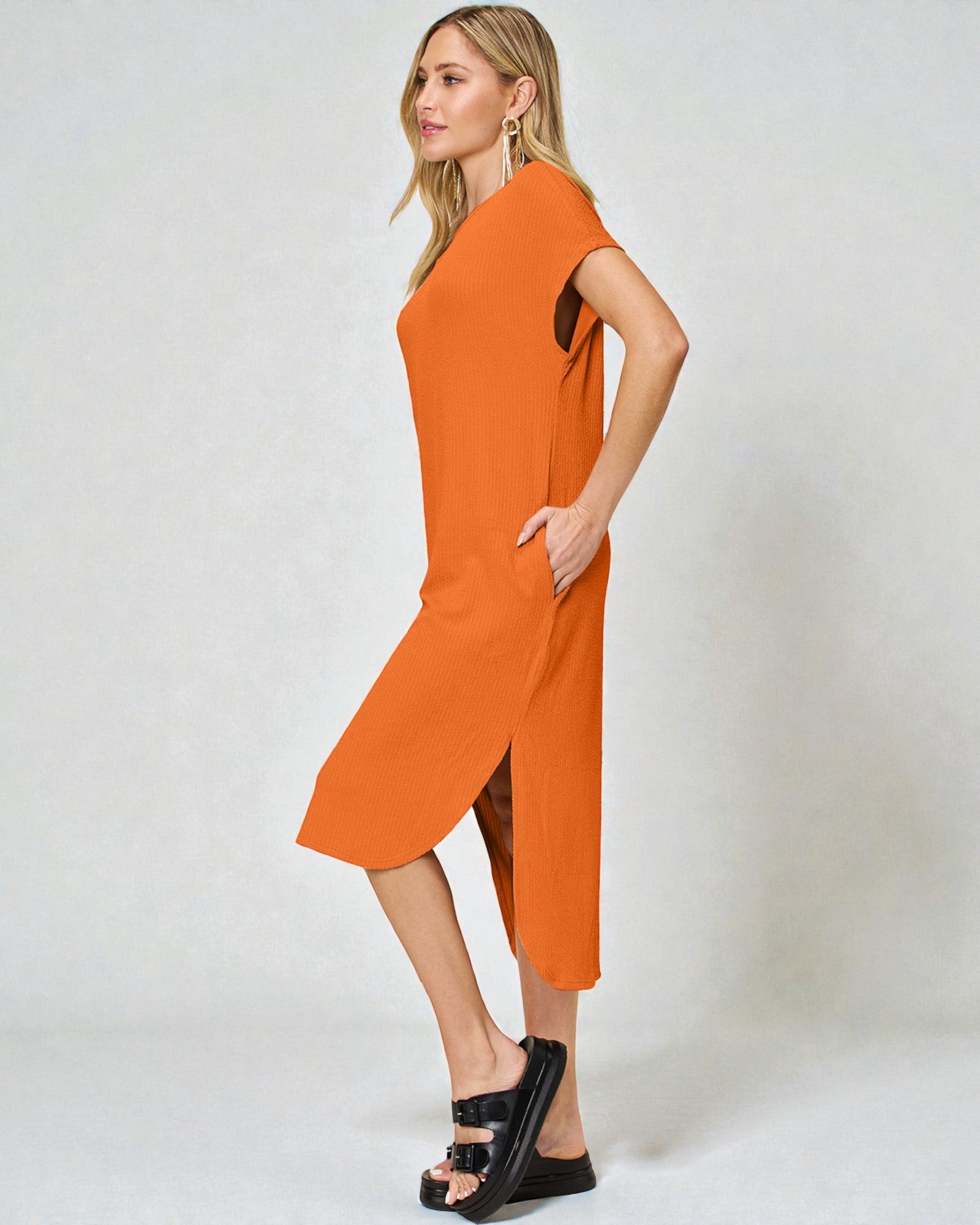 Woman wearing an orange dress on a white background