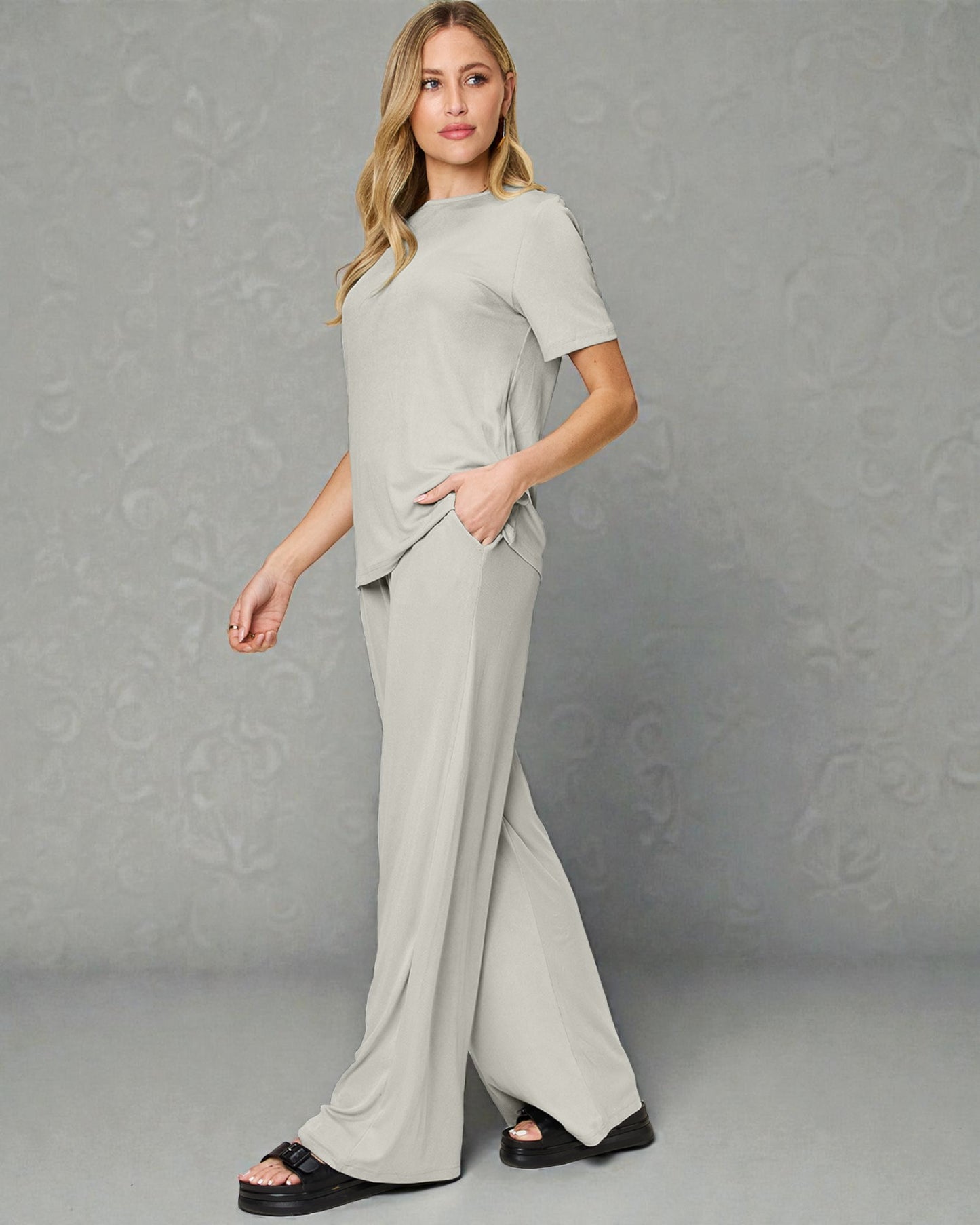 Woman wearing a gray outfit against a gray background