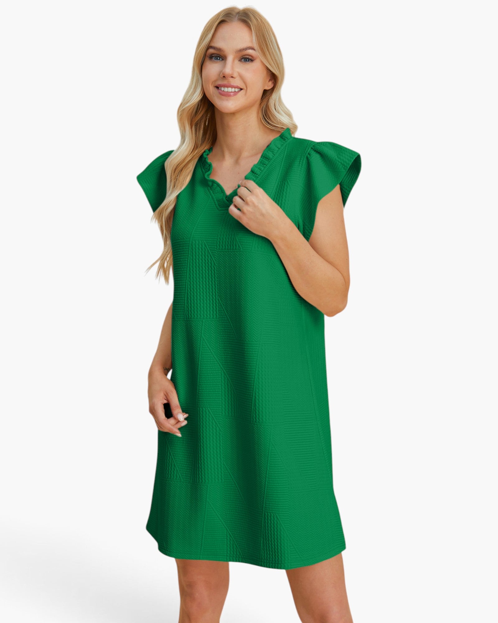 A woman modeling a bright green short-sleeve dress with a ruffled V-neckline, photographed against a clean white studio background.